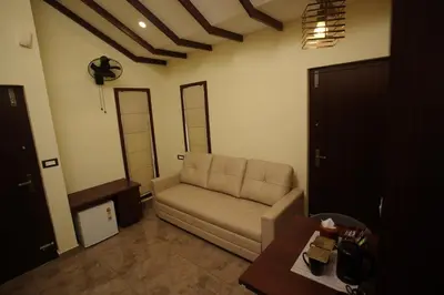 a living room with a couch and a table at Pabis luxurious stay in Vythiri