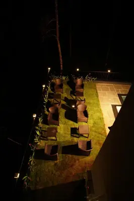 an overhead view of a table with chairs and lights at Pabis luxurious stay in Vythiri