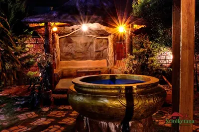 a large stone tub in front of a room at Sriniketana Homestay in Madikeri