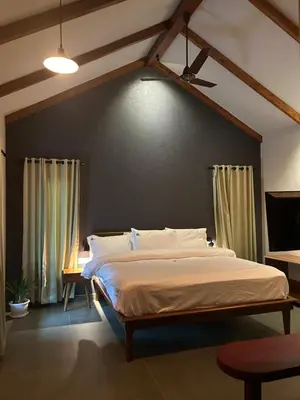 a bedroom with a large bed in a room at SylVan Resort in Wayanad