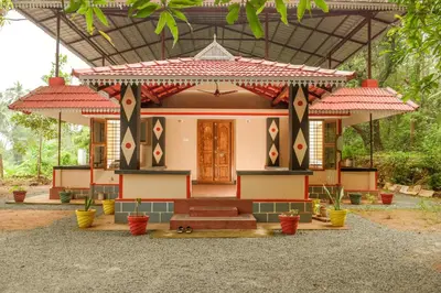 a small house with a red roof at Villa in the woods in Trichūr