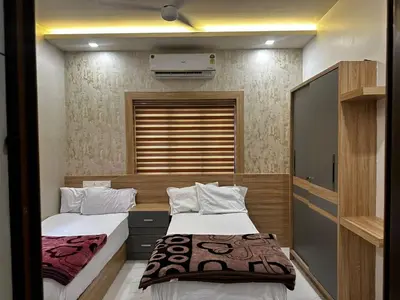 a bedroom with two beds and a window at MEDURE International in Kottakkal