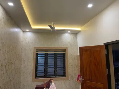 a room with a ceiling fan and a window at MEDURE International in Kottakkal