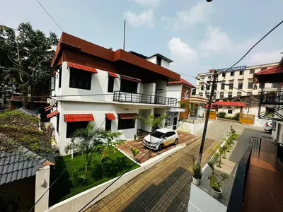 an apartment building with a car parked in front of it at MEDURE International in Kottakkal