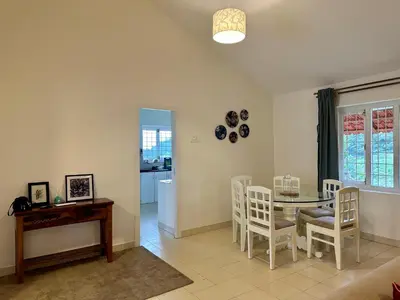 a dining room with a table and chairs at Hoopoe House, Ooty in Ooty