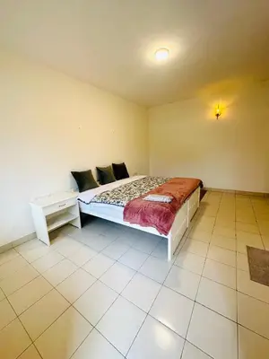 a bedroom with a bed and a table in it at Hoopoe House, Ooty in Ooty