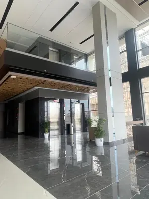 an empty lobby with potted plants in a building at PRESIDENCY AIRPORT HOTEL in Cochin