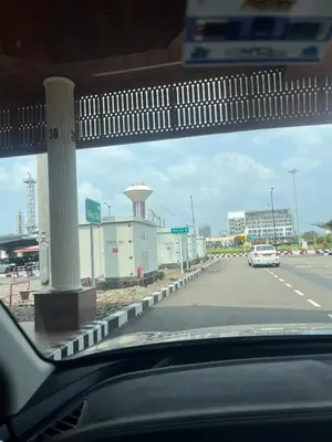 a car driving down a road with a gas station at PRESIDENCY AIRPORT HOTEL in Cochin