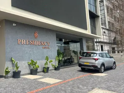 a silver car parked in front of a building at PRESIDENCY AIRPORT HOTEL in Cochin