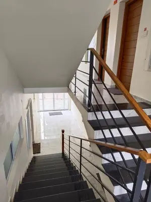 a staircase in a house with black and white stairs at Shams al Imarat in Palakkad