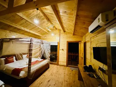 a bedroom with a bed with a net at Coorg Jungle Mist in Madikeri
