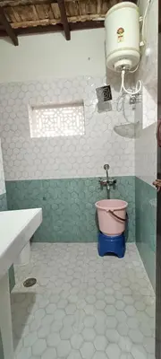 a bathroom with a sink and a toilet at xplorest in Mysore