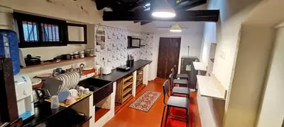 a kitchen with a counter and some chairs in it at xplorest in Mysore