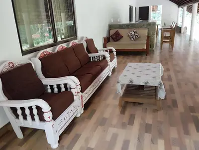 a living room with a couch and a coffee table at Creek Side in Madikeri