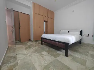a bedroom with a large bed in a room at Waterfall Villa - 4BHK in Mysore
