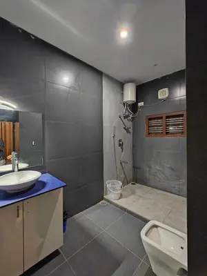 a bathroom with a sink and a toilet and a shower at Beautiful 4bhk Duplex Villa in Mysore