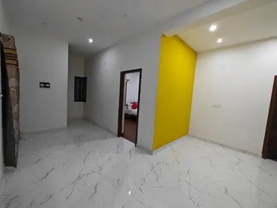 a hallway with yellow and white walls and a door at Beautiful 4bhk Duplex Villa in Mysore