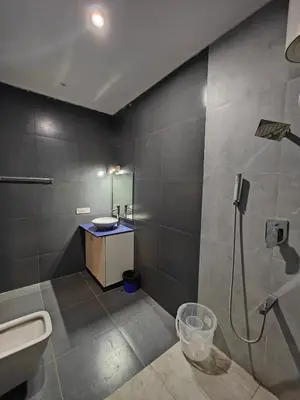 a bathroom with a shower and a sink and a toilet at Beautiful 4bhk Duplex Villa in Mysore