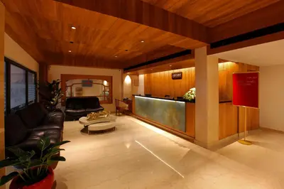 a living room with a couch and a table at HOTEL PRINCE in Kāladi