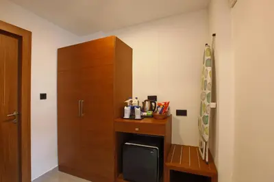 a room with a wooden cabinet and a desk at HOTEL PRINCE in Kāladi