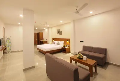 a hotel room with a bed and a couch at HOTEL PRINCE in Kāladi