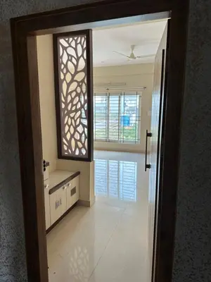 a bathroom with a mirror and a sink in a room at Oryx Hotel Apartments in Mysore