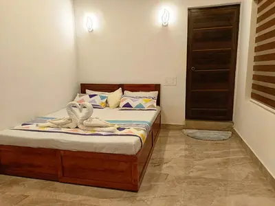 a bedroom with a bed with towels on it at Paradise Homestay in Wayanad