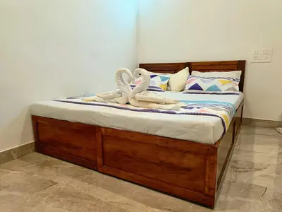 two swans towels are sitting on a bed at Paradise Homestay in Wayanad