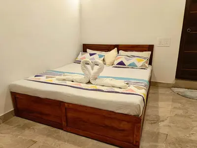 a bedroom with a bed with towels on it at Paradise Homestay in Wayanad