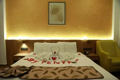 a hotel room with a bed with a sign on it at SKY PENTA RESIDENCY in Iritti