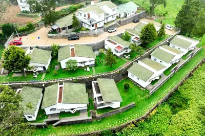 an aerial view of a village with houses at Green Wood Hill Cottage in Ooty