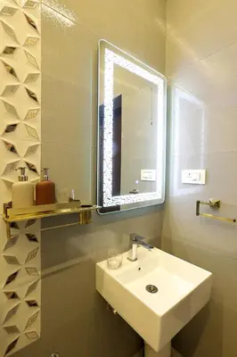a bathroom with a sink and a mirror at Green Wood Hill Cottage in Ooty
