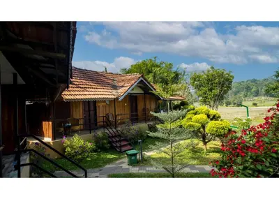 a house with a garden in front of it at Mystery Maze Resort and Spa in Wayanad