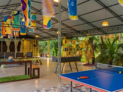 a ping pong room with a ping pong table at The Hosteller Wayanad, Vythiri in Vythiri