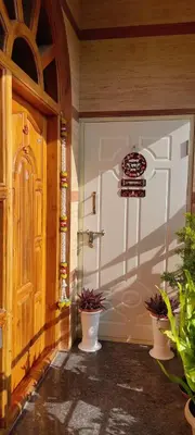 a garage door with potted plants in front of it at Vrindavan - An Artists Nook in Mysore
