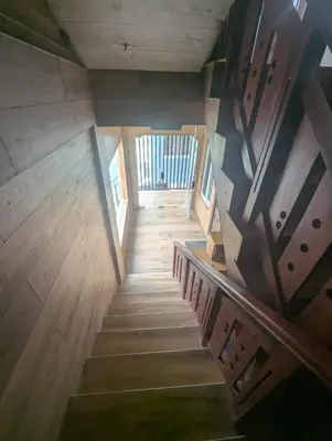 an overhead view of a wooden staircase in a house at Mountain Mist Meadows in Ooty