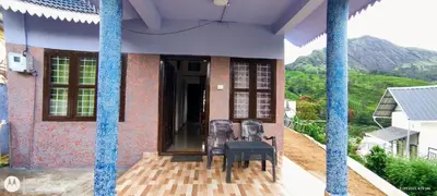 a group of chairs sitting on the porch of a house at Hiya Holidays in Munnar