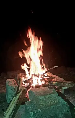 a large fire in a stone oven at night at Hiya Holidays in Munnar
