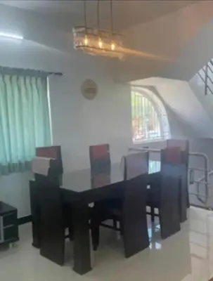 a dining room with a black table and chairs at White House Kotagiri, 2bhk in Kotagiri