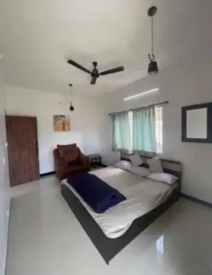 a bedroom with a bed and a ceiling at White House Kotagiri, 2bhk in Kotagiri