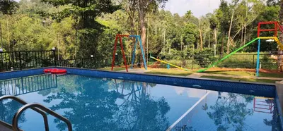 an empty swimming pool with a playground at TREE6 WAYANAD in Vythiri