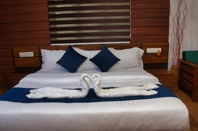 a bed with two towels in the shape of hearts at TREE6 WAYANAD in Vythiri
