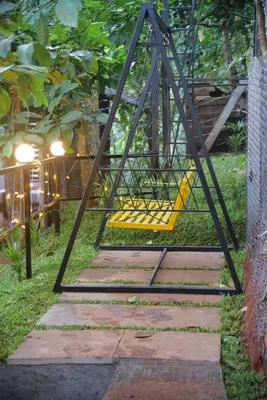 a swing set in the middle of a garden at TREE6 WAYANAD in Vythiri