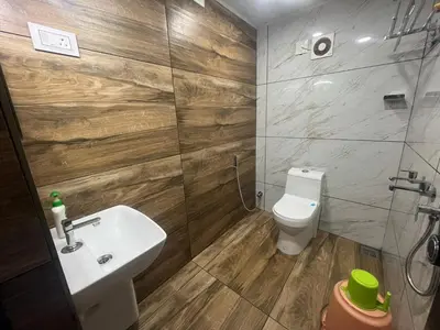 a bathroom with a sink and a toilet at Vyshnavi Home stay in Thanniyam