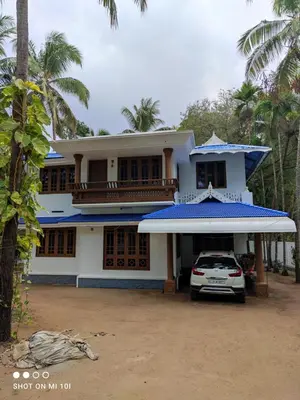 a house with a car parked in front of it at Vyshnavi Home stay in Thanniyam