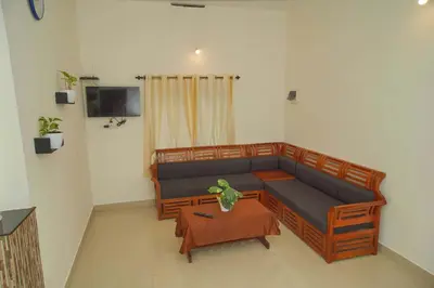 a living room with a couch and a table at Vythiri Garden in Vythiri