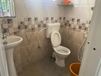 a bathroom with a toilet and a sink at Spacious 2BHK for upto 12 Guests , Best for Families & Groups in Mysore
