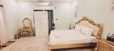 a bedroom with a white bed and a table at CSR Landmark Resorts in Coimbatore