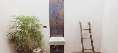 a bathroom with a sink and a ladder next to a plant at CSR Landmark Resorts in Coimbatore