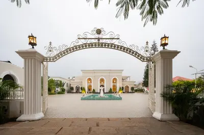 an archway leading to a courtyard with a fountain at CSR Landmark Resorts in Coimbatore